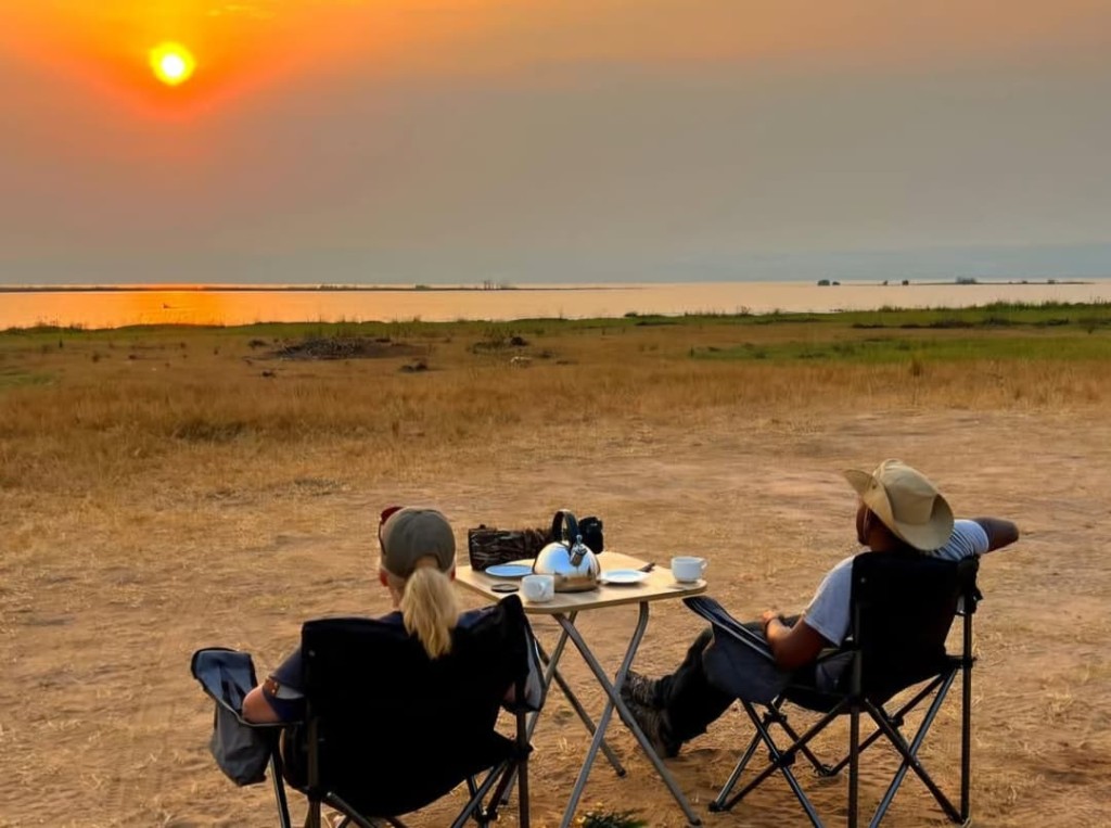 Couple enjoying a private sundowner overlooking the Nile at Murchison Falls