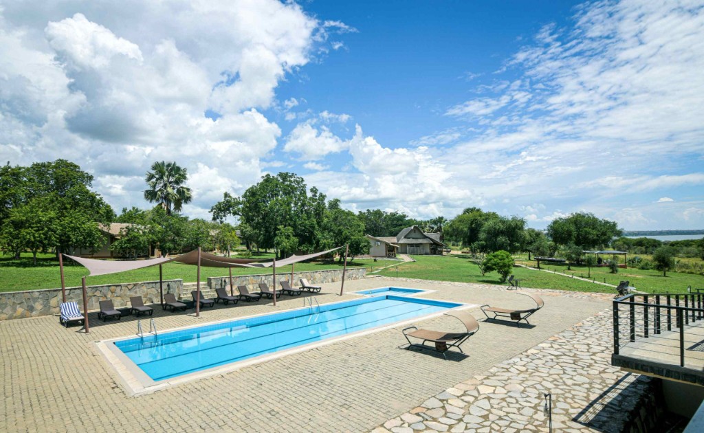Midday rest at a Murchison Falls safari lodge swimming pool terrace