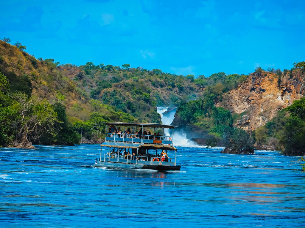 Double-decker Nile boat approaching the base of Murchison Falls mist